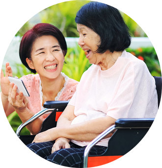 caregiver and senior woman laughing